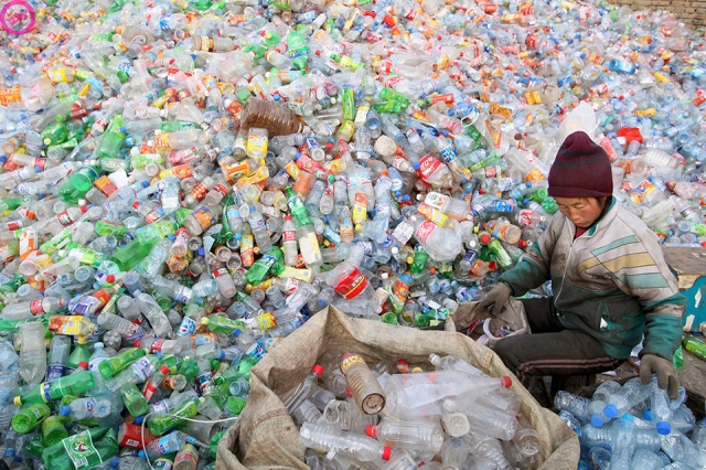 Chinese migrant workers sort through industrial and household waste at a recycling centre in Beijing, China